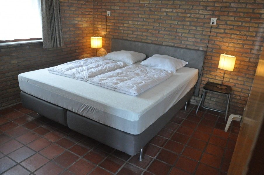 Comfortable bedroom in Jans bungalow, Ballum, Ameland, with double bed and mood lighting.