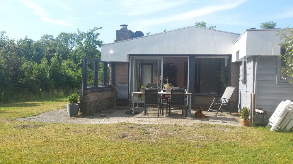 Spacious terrace of Jans vacation home in Ballum, Ameland, ideal for relaxing in nature.