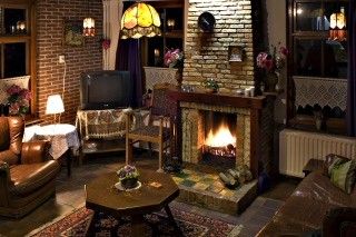 Cozy living room with fireplace in vacation home Suzan, Ballum, Ameland, a warm place in the Wadden Islands.