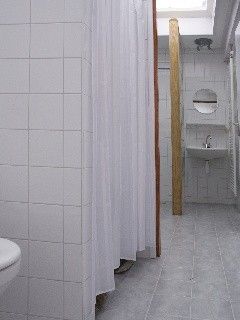 Modern bathroom in vacation home Suzan, Ballum, Ameland with shower and sleek tiles, comfort on the Wadden Islands.