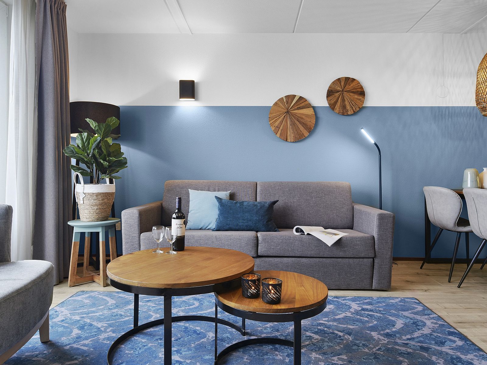 Modern interior space of Ameland State apartment in Nes, Ameland, with open kitchen and sitting area.