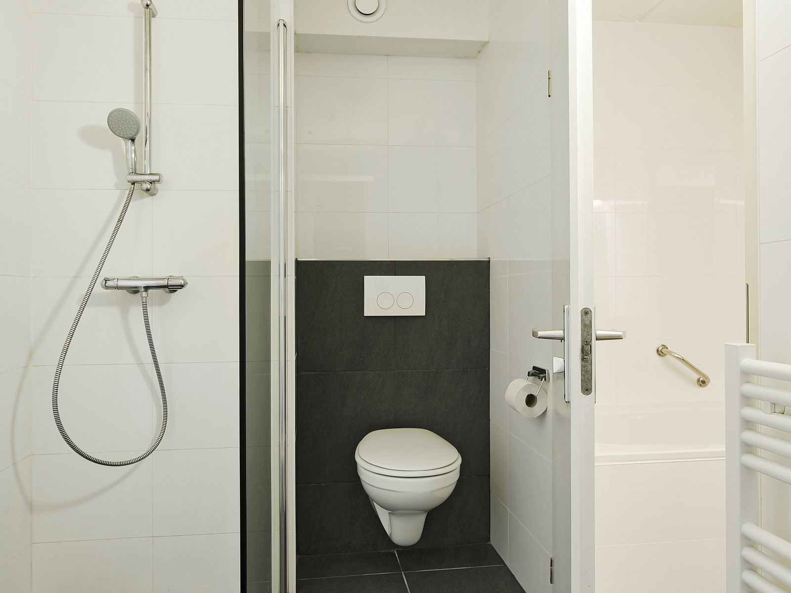 Detail of the bed in Ameland State apartment, Nes, Ameland, with pillows and magazine.