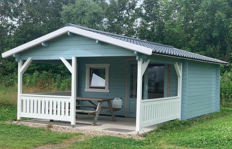 Vacation home in Workum, a charming vacation home on the IJsselmeer, offers an inviting veranda amid the Frisian lakes.