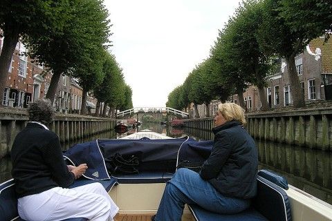 Boat trip through historic canals near Recreation Company 'on the water', Heeg, Frisian lakes.