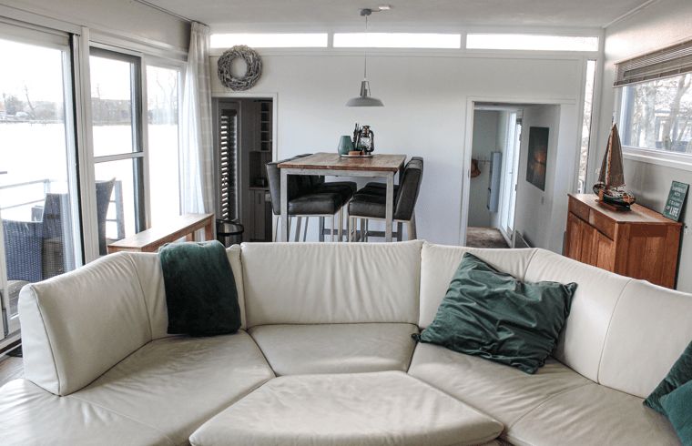 Cozy living room in Holiday Home in Oudega, near Heegermeer, with comfortable seating area and views of the Frisian lakes.