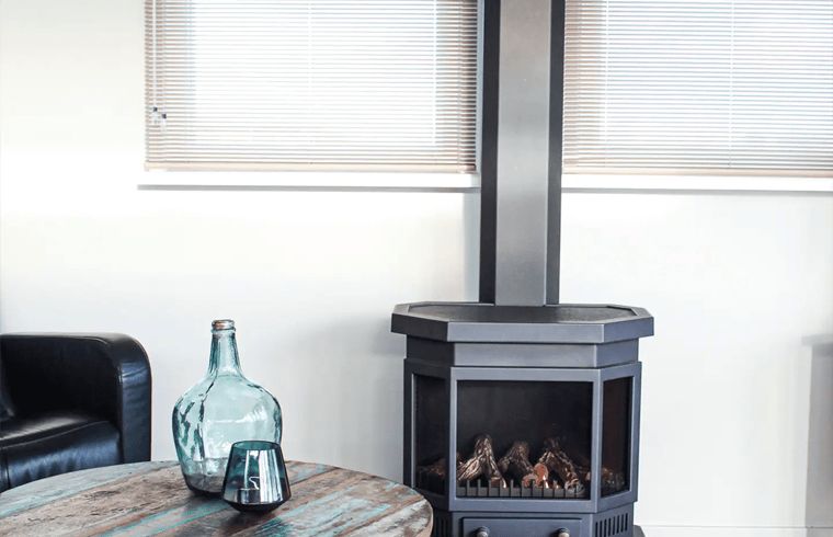 Cozy living room in Holiday Home in Oudega, Heegermeer with modern fireplace and comfortable furnishings, ideal for a relaxing stay.