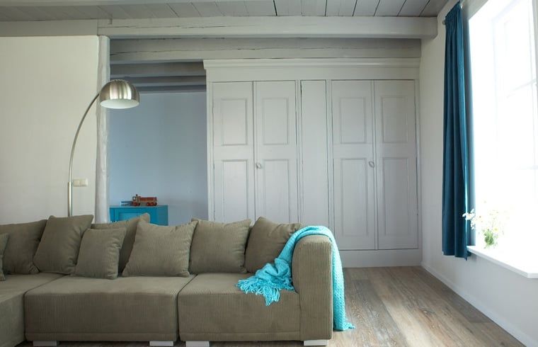 Stylish indoor space in Holiday Home in Kollumerpomp, Lauwersmeer, with comfortable sofa and cozy furnishings.