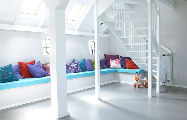 Playful sitting area in Holiday Home in Kollumerpomp, Lauwersmeer, with colorful cushions and lots of natural light.