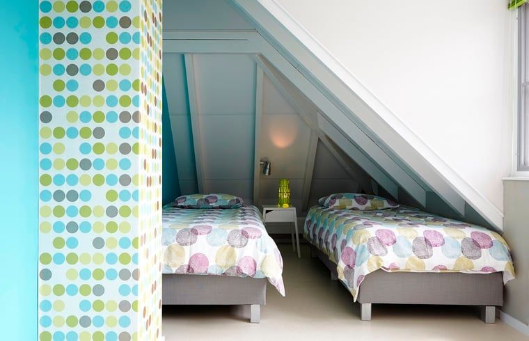 Bedroom with colorful accents in Holiday home in Kollumerpomp, Lauwersmeer, ideal for a relaxing stay.