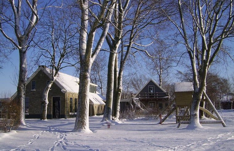 Winter landscape at Holiday home in Kollumerpomp, Lauwersmeer, with snowy trees and serene surroundings.