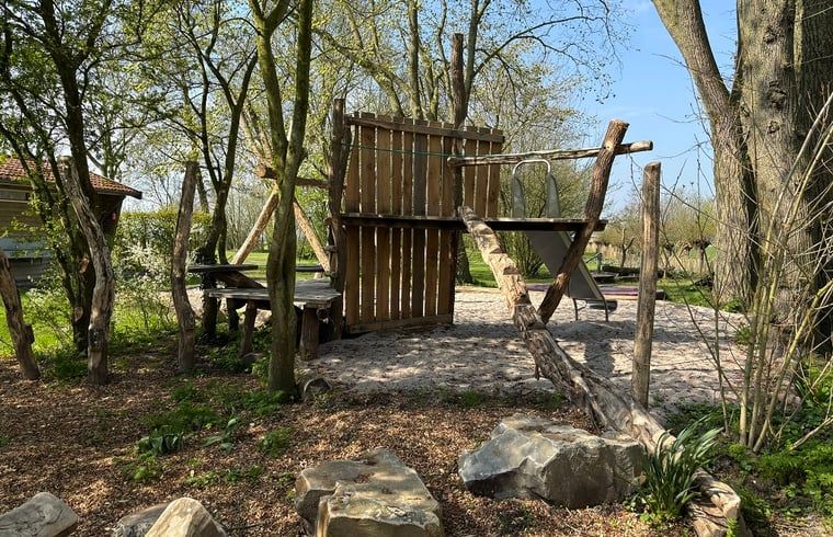 Adventure playground at Holiday home in Kollumerpomp, Lauwersmeer, with wooden climbing equipment and green surroundings.