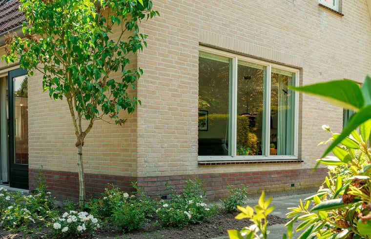 Buitenkant van Vakantiehuis in Schoonloo, Midden Drenthe, met groene omgeving.