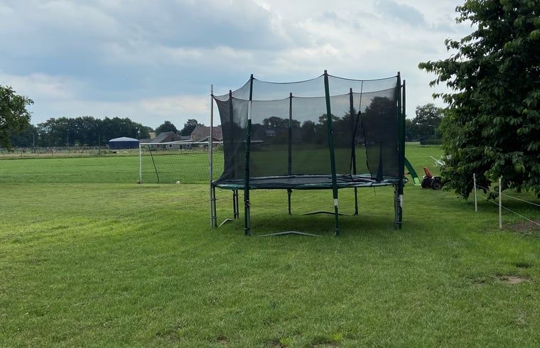 Trampolin im Garten des Ferienhauses in Beilen, Zentral-Drenthe, fuer Spass und Entspannung.