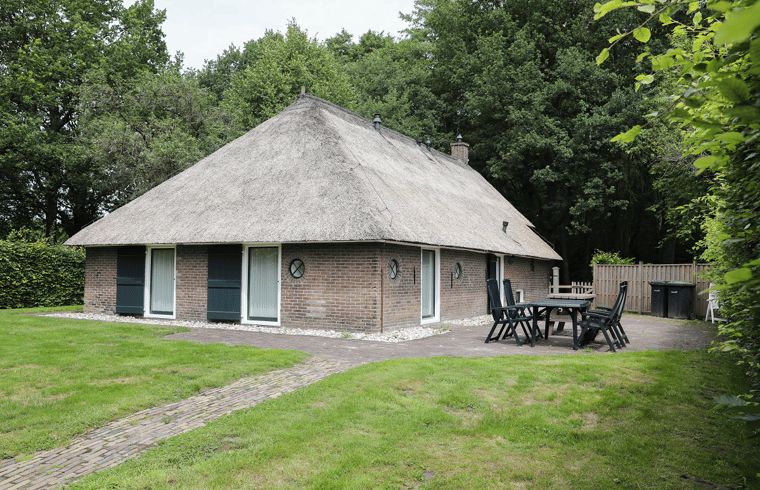 Spacious terrace at vacation home in Orvelte, Central Drenthe, ideal for outdoor meals.