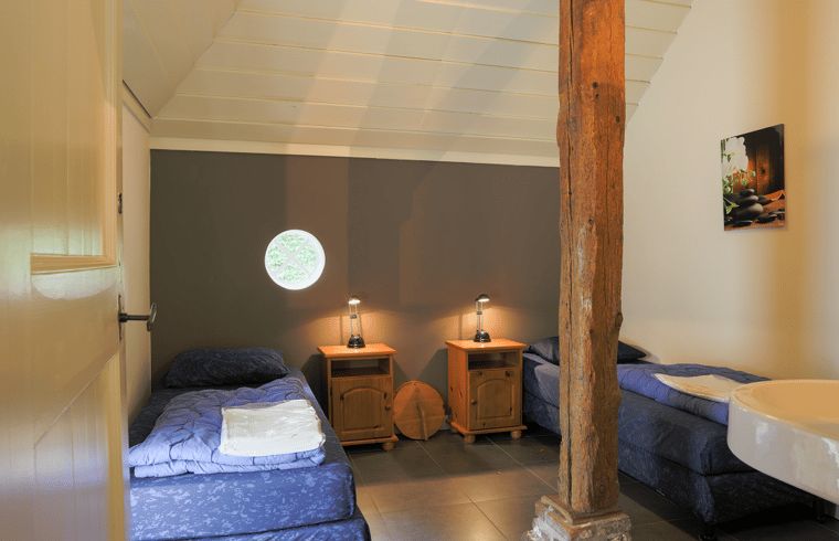 Cozy bedroom in vacation home in Orvelte, Central Drenthe, with rustic details.