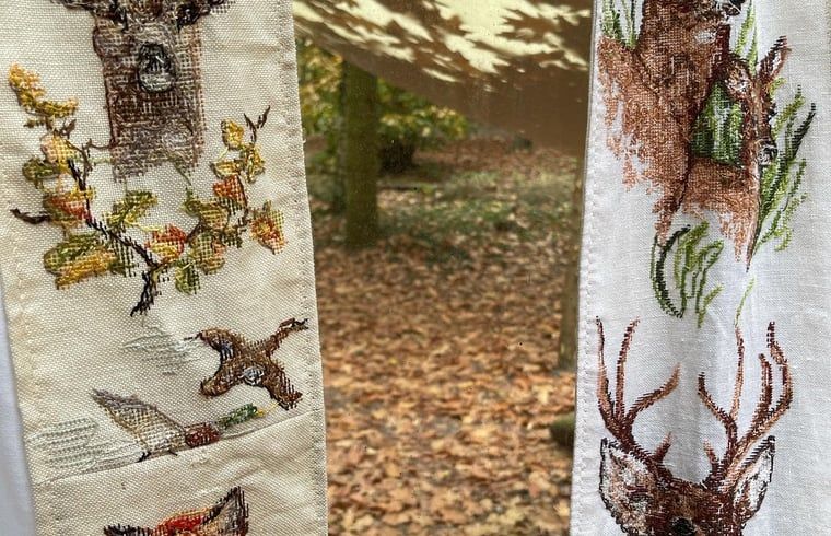 Cozy autumn decor in the Cottage in Papenvoort, vacation home in Drenthe, with embroidered curtains and woodland setting.