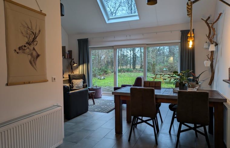 Gezellige eetkamer in Vakantiehuis in Westerbork met uitzicht op de tuin, ideaal voor familiediners in Midden Drenthe, Drenthe.