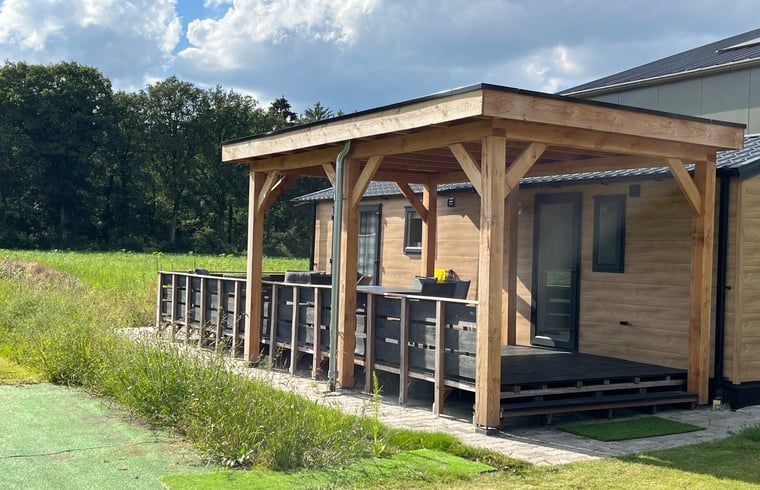 Porch of Holiday Home in Eeserveen, Drenthe overlooking green fields.
