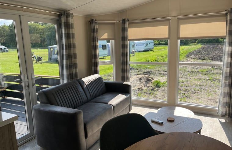 Bright living room in Holiday home in Eeserveen, Drenthe overlooking nature.