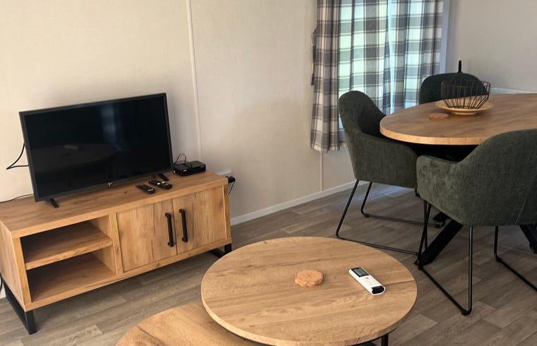 Dining and sitting area in Holiday Home in Eeserveen, Drenthe with modern furniture.