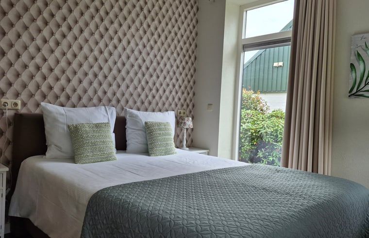 Attractive bedroom in Holiday Home in Dalerveen, Southeast Drenthe, with views of green surroundings and stylish furnishings.