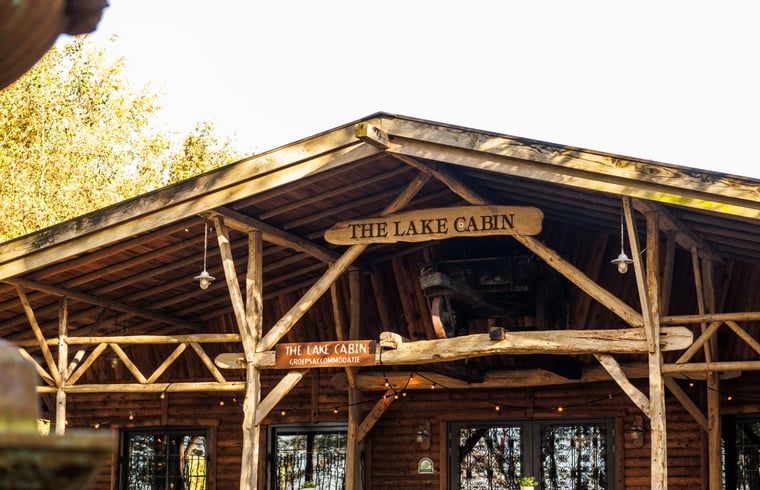Cottage in Erm, vacation home in Southeast Drenthe with rustic wooden porch surrounded by nature.