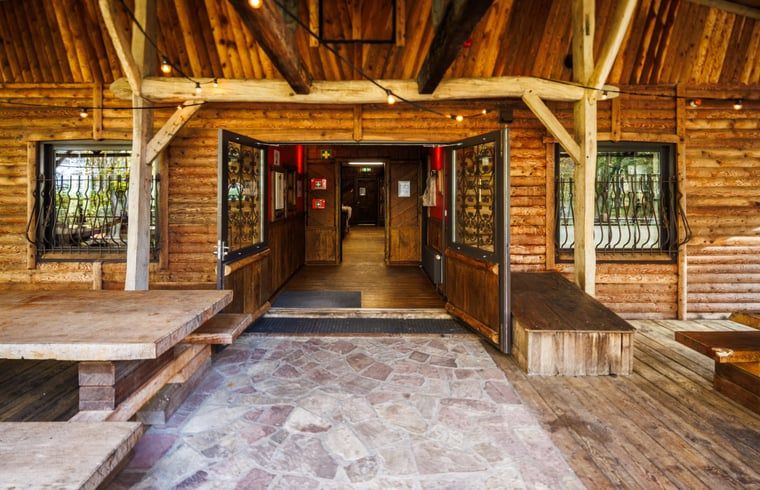 Welcoming entrance to the Cottage in Erm, a cozy vacation home in Southeast Drenthe, with a rustic wooden porch.