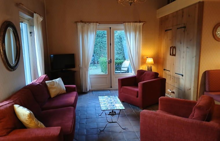Cozy living room in Holiday Home in Stieltjeskanaal, Southeast Drenthe, with comfortable seating and garden views.