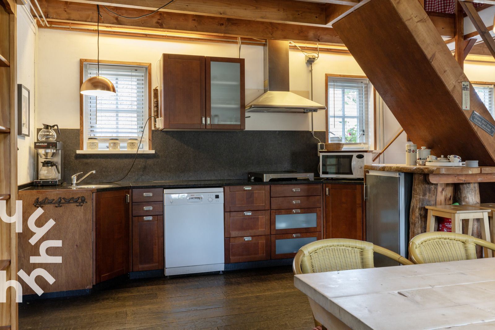 Offene Kueche in DG053, Diever mit Esstisch aus Holz und modernen Geraeten.