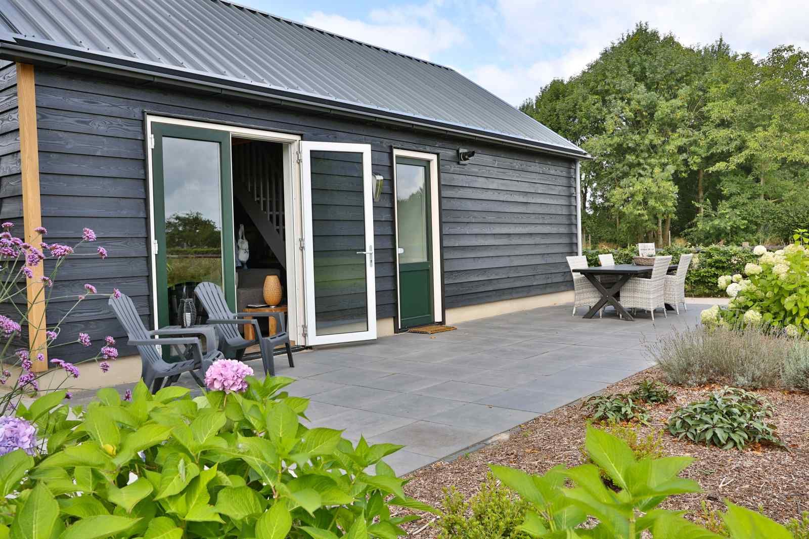 Spacious living room with wooden ceiling in DG1415, vacation home in Zuidwolde, Drenthe.