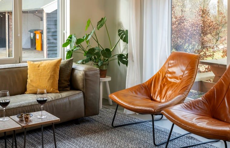 Eetruimte in Vakantiehuisje in Dwingeloo, Zuidwest Drenthe, met stijlvolle stoelen en zonnig uitzicht.