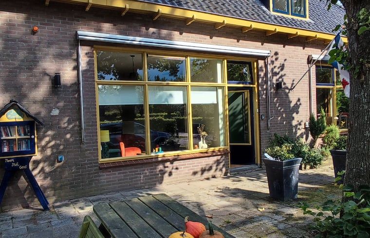 Gemuetliches Wohnzimmer im Ferienhaus in Dwingeloo, Suedwest-Drenthe, mit viel Licht und bequemen Sitzgelegenheiten.