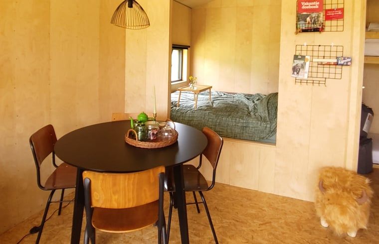 Dining table and sleeping area in Holiday cottage in Vledder, Southwest Drenthe, with cozy atmosphere.