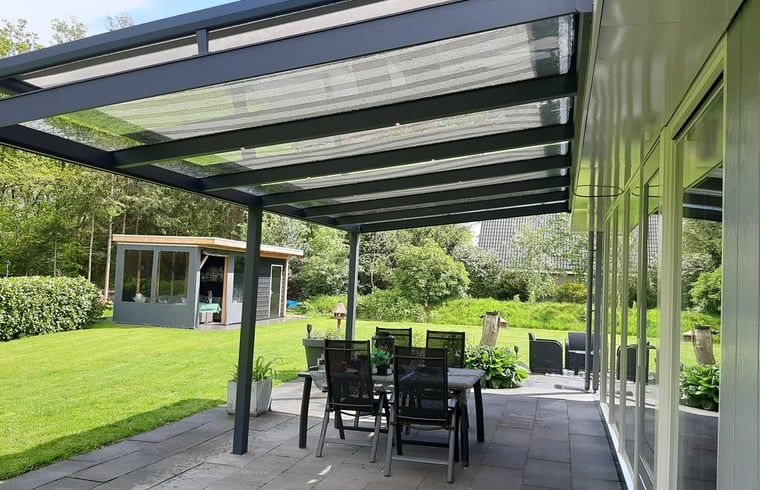 Atmospherically lit patio in Holiday Home in Wittelte, Southwest Drenthe, for evening meals outside.