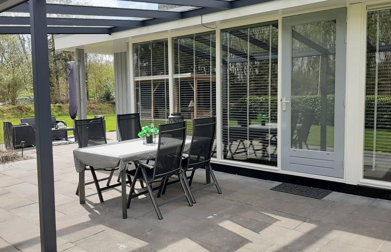 Stylish dining area in Holiday Home in Wittelte, Southwest Drenthe, overlooking the garden.