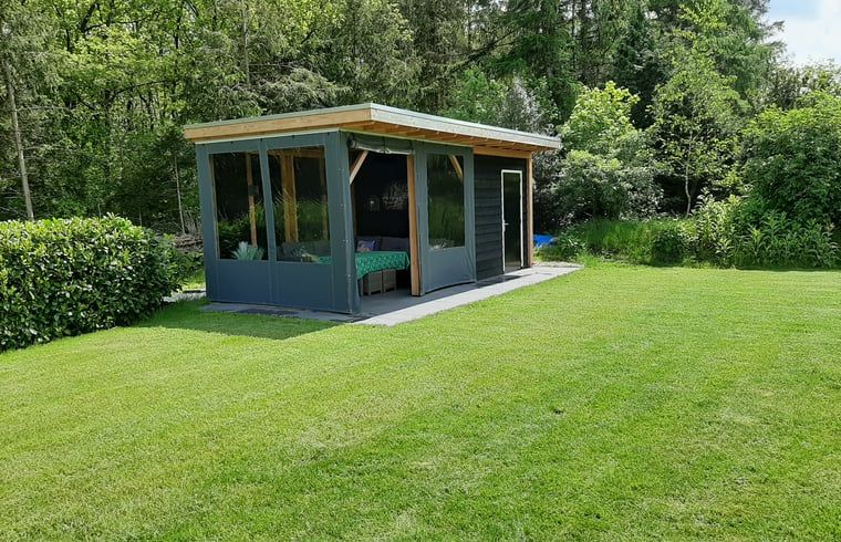 Cozy sitting area in Holiday Home in Wittelte, Southwest Drenthe, with atmospheric lighting.