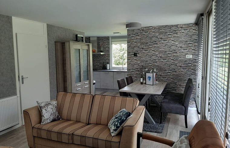 Cozy sitting area with fireplace in Holiday Home in Wittelte, Southwest Drenthe.