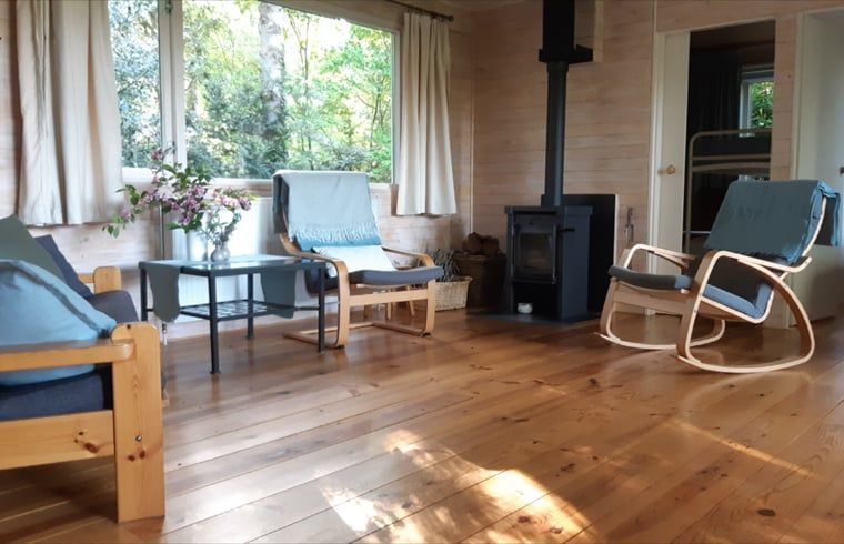 Warm sitting area with wood stove in Cottage in Koekange, vacation home in Southwest Drenthe, surrounded by nature.