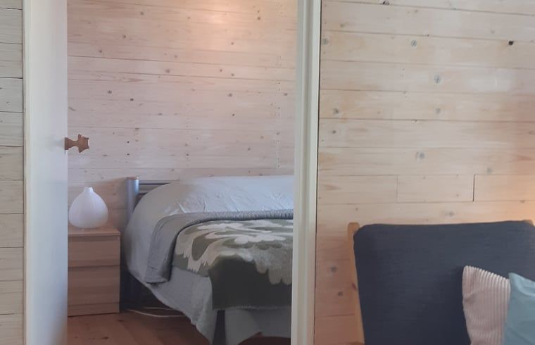 Cozy bedroom with wooden walls in Cottage in Koekange, vacation home in Southwest Drenthe, for a good night's sleep.