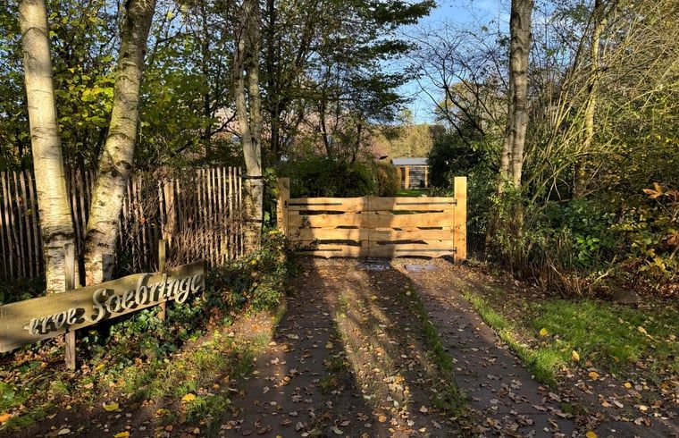 Eingangstor des Ferienhauses in Ansen, Suedwest-Drenthe, umgeben von Natur.