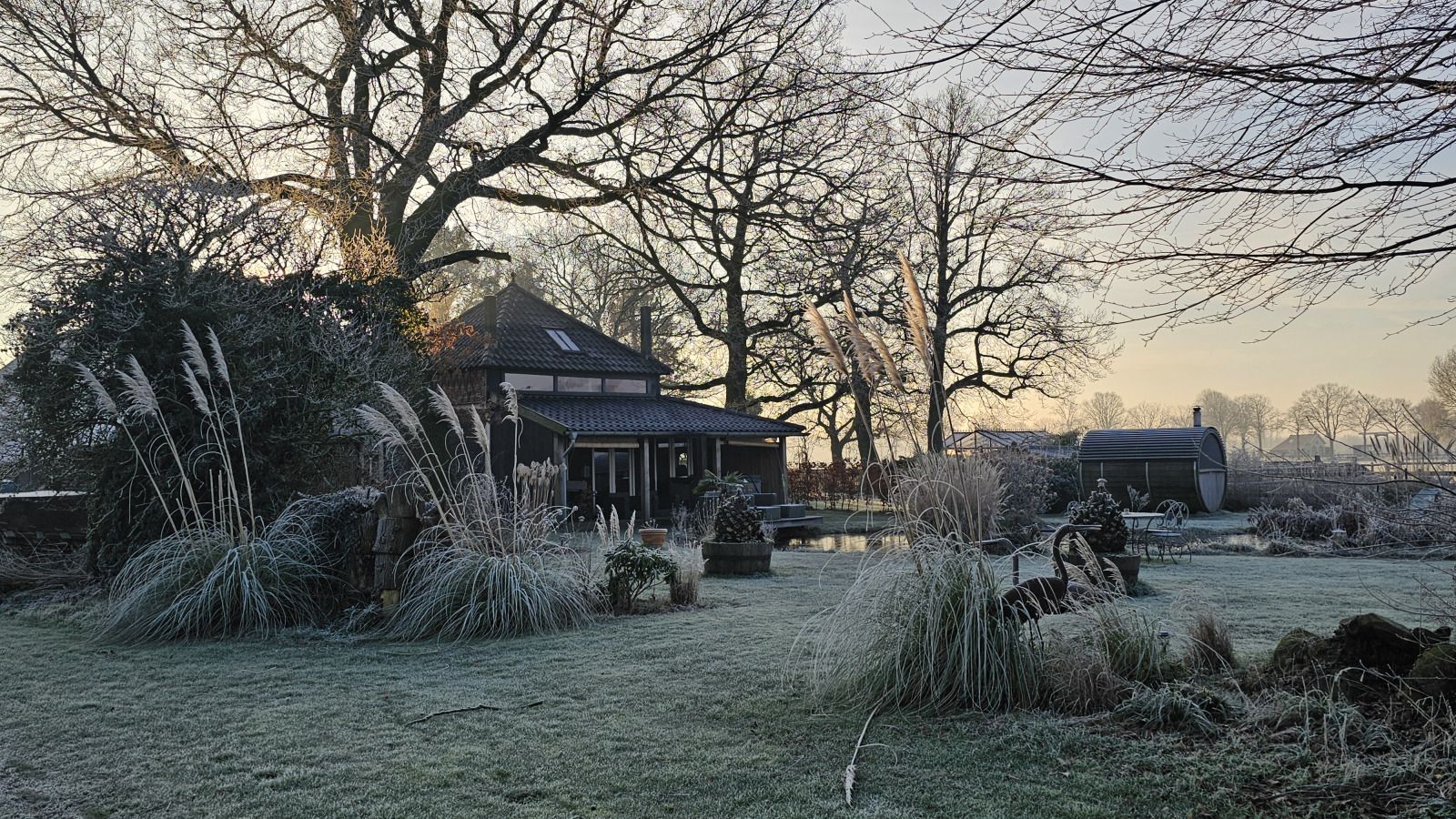 Vacation home DG2027 in Dieverbrug, Southwest Drenthe, surrounded by green nature and a retro camper in the foreground.