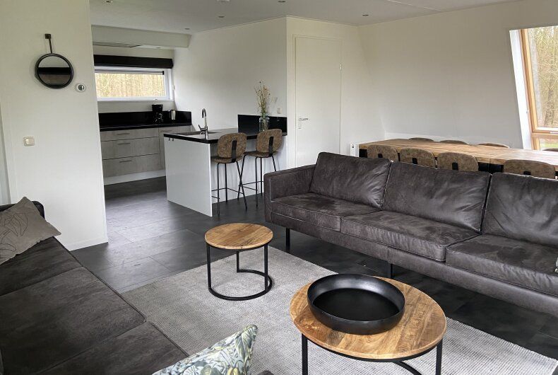 Spacious living room of detached house in Biddinghuizen, Eastern Flevoland, with modern furnishings and comfortable seating area.