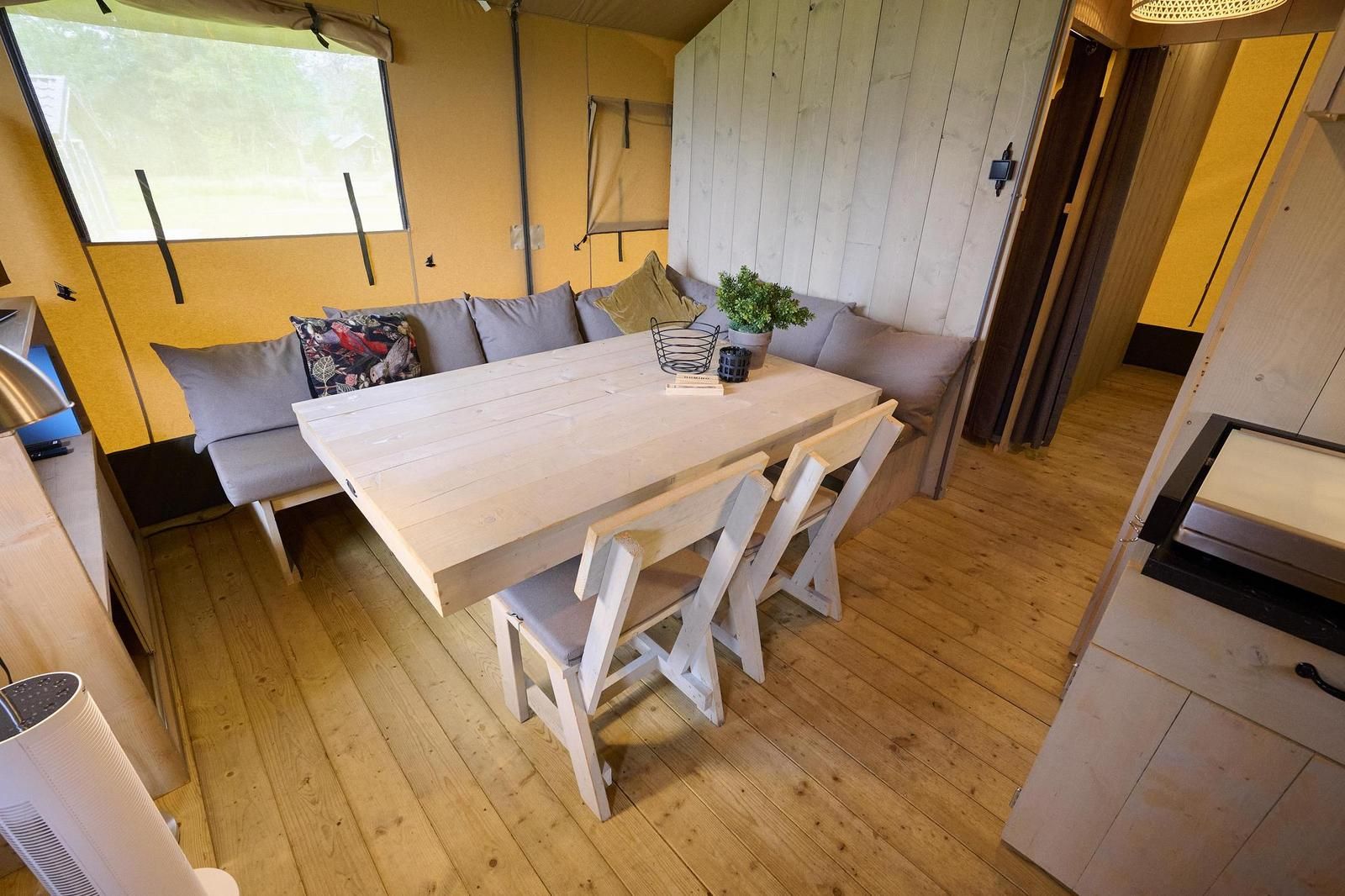 Spacious dining room in Safari Tent Wood, Biddinghuizen, ideal for a cozy meal in Flevoland.