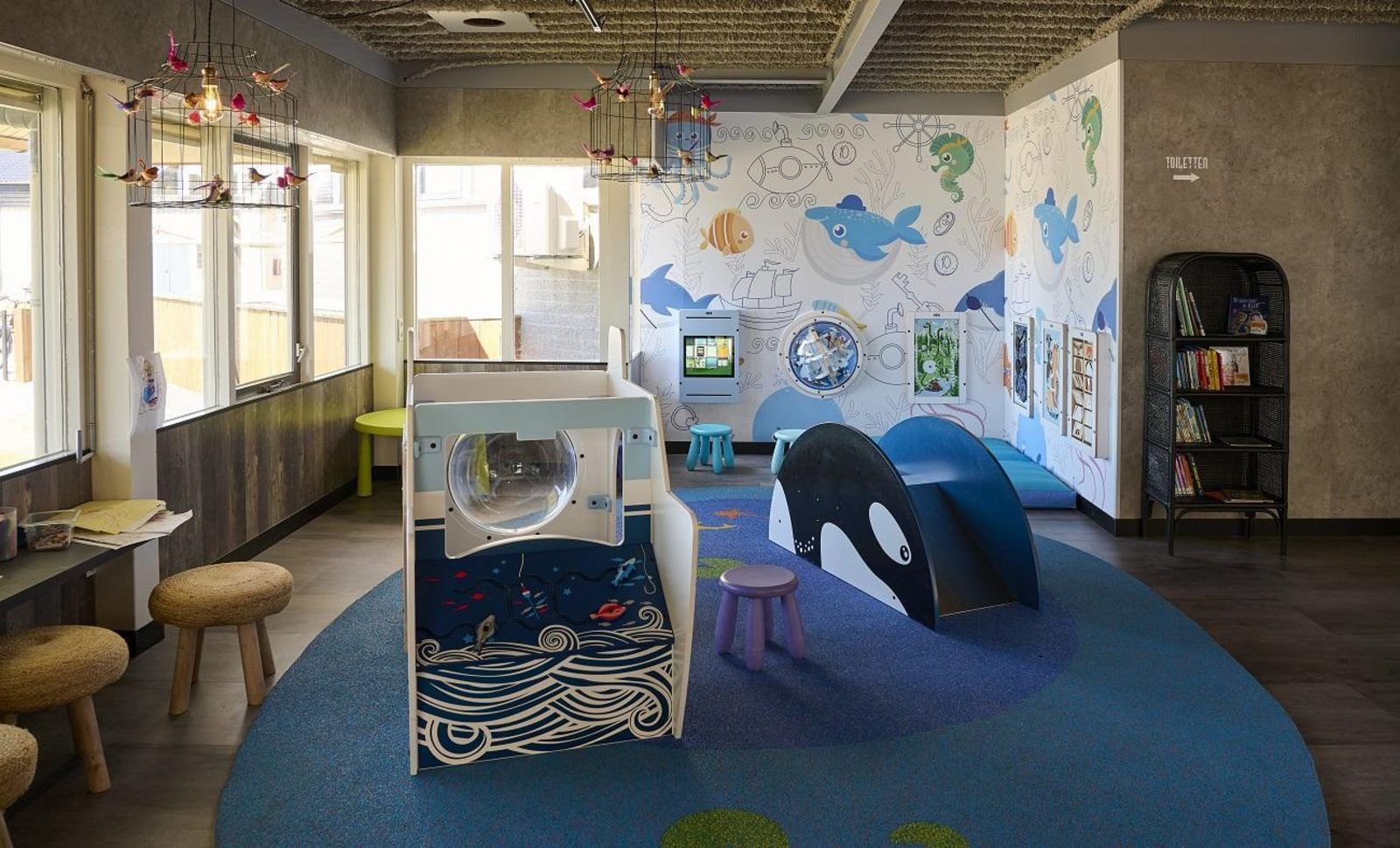 Children's corner in Safari Tent Wood, Biddinghuizen, with colorful play equipment and books in Flevoland.