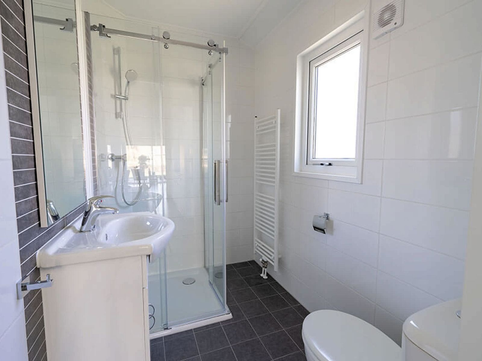 Stylish bathroom in Chalet in Biddinghuizen with modern shower and fresh look.