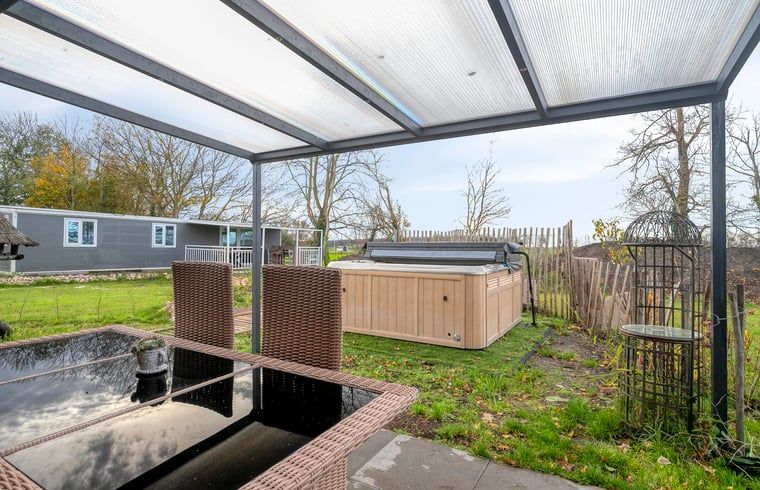 Illuminated jacuzzi by night at Holiday Home in Dronten, Eastern Flevoland, for ultimate relaxation in serene surroundings.