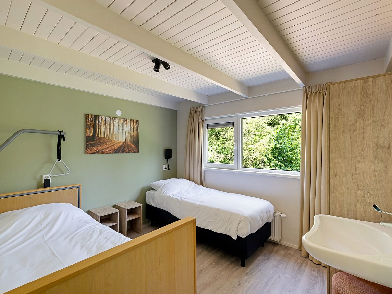 Slaapkamer in Aangepaste bungalow de Dobbe in Appelscha, Friese bossen, met comfortabele bedden en uitzicht op de groene natuur van Friesland.