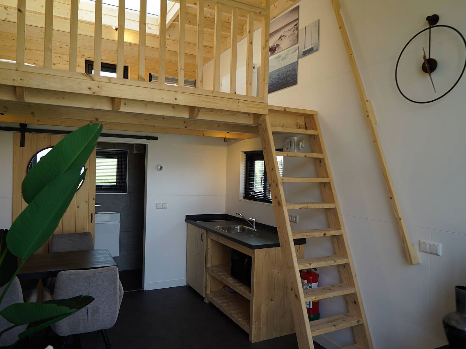 Interior of Chalet in Hindeloopen, Friesland, with wooden interior and stairs to sleeping loft.
