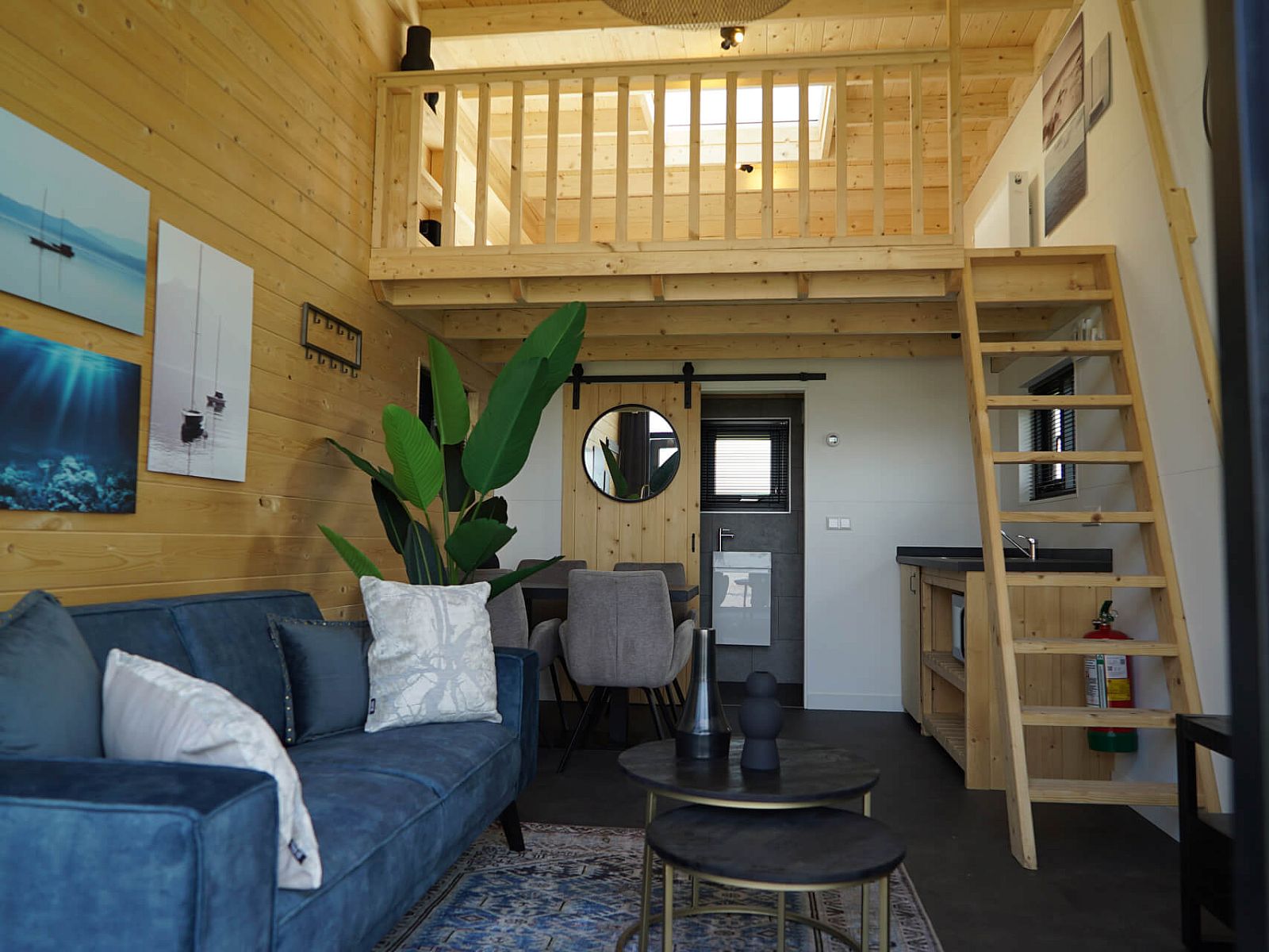 Stylish living room in Chalet in Hindeloopen, Friesland, with comfortable sofa and wooden details.
