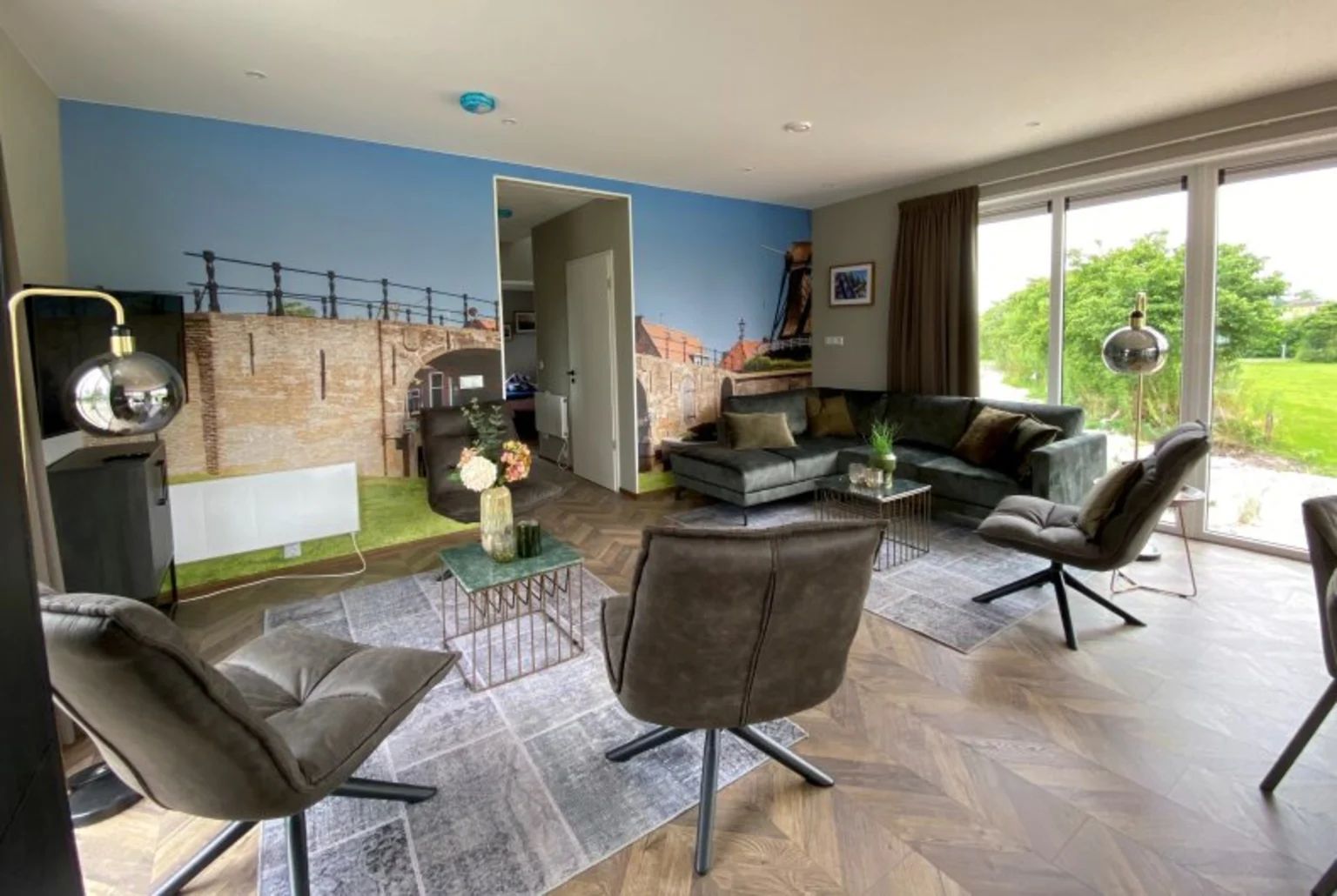 Stylish living room in the detached house in Hindeloopen, Friesland, with modern interior and views of green surroundings.